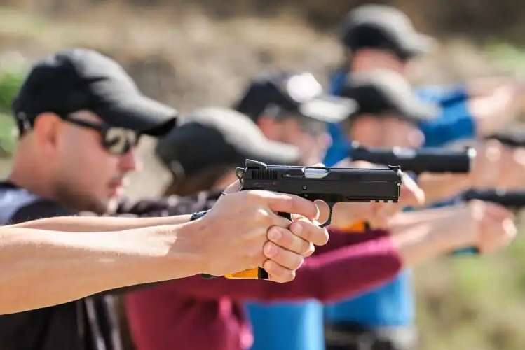 Shooting-class-web_cropped Two students firing pistols at a shooting range during a Pistol Operator Fundamentals course by Hawthorne Research, Training and Development.